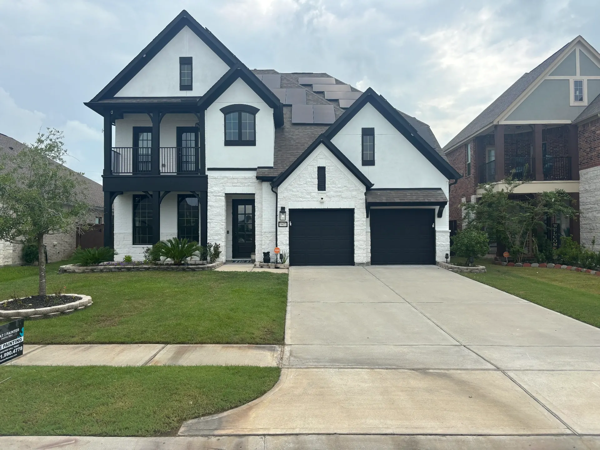 Two-story painted brick exterior in modern charcoal grey