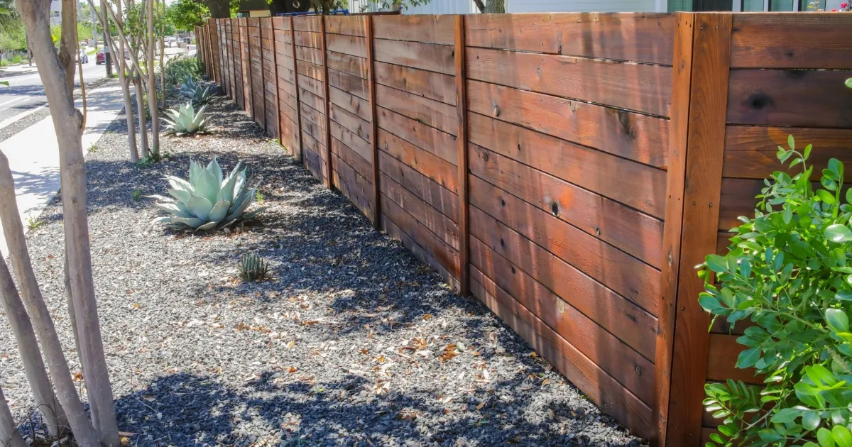 Backyard fence and gate restained in matching semi-transparent finish