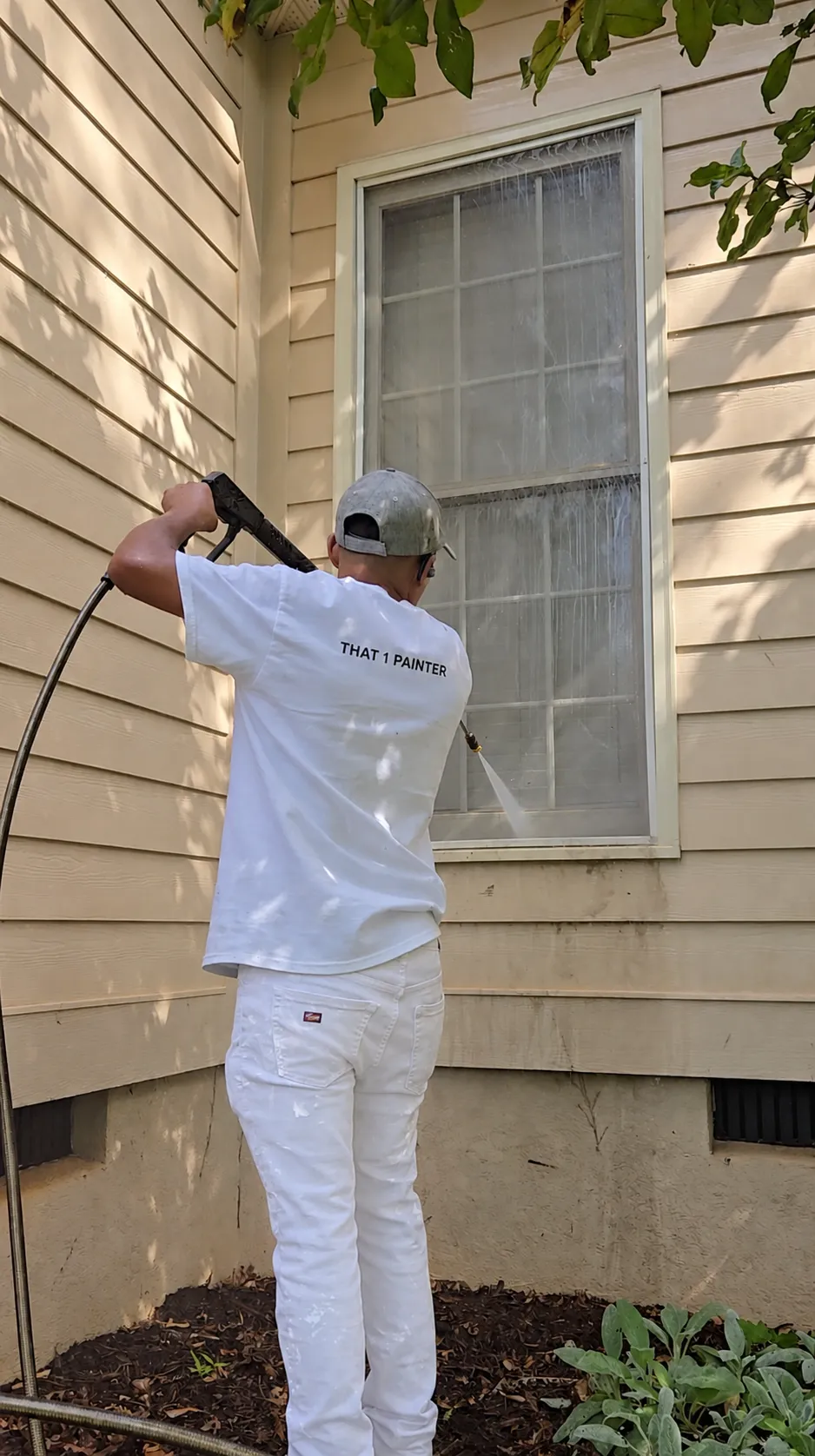 Pressure washing window and siding on a home exterior