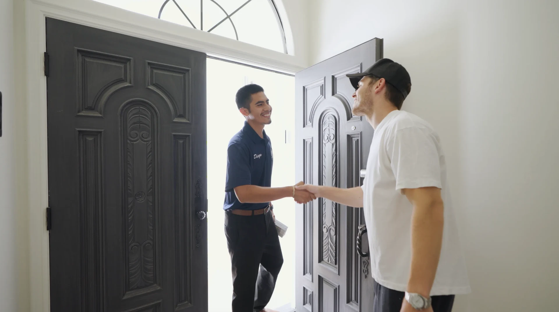 That 1 Painter project manager greeting a homeowner at the front door for a caulking inspection